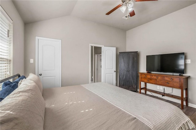 bedroom with hardwood / wood-style flooring, ceiling fan, and lofted ceiling