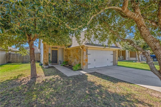 view of front of house featuring a front yard and a garage