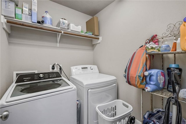 clothes washing area featuring washer and dryer