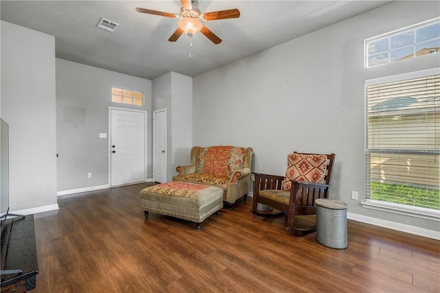 sitting room with dark hardwood / wood-style flooring and ceiling fan