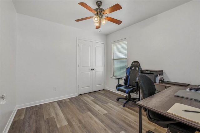 office with ceiling fan and light hardwood / wood-style floors