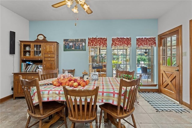 dining area featuring light tile patterned floors, a wealth of natural light, and ceiling fan