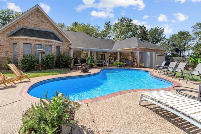 view of swimming pool with a patio