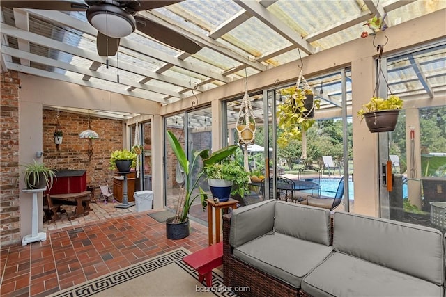 sunroom / solarium featuring ceiling fan