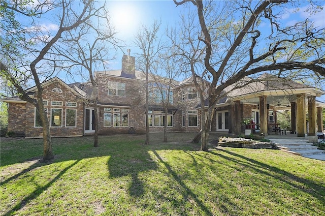 1650 Bird Pond Rd, College Station, TX 77845 - rear view of house featuring french doors, a yard, ceiling fan, and a chimney