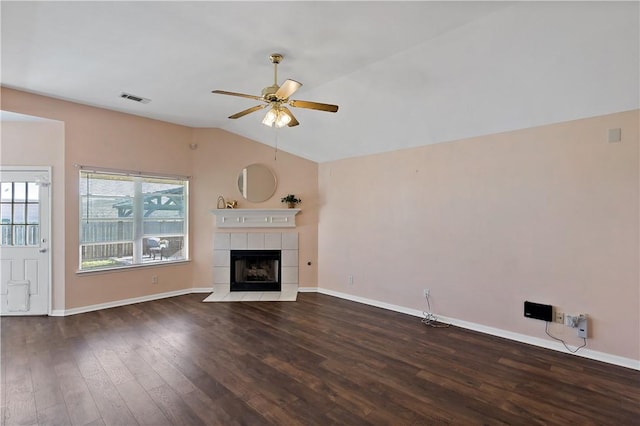 unfurnished living room with wood finished floors, baseboards, a ceiling fan, vaulted ceiling, and a tiled fireplace