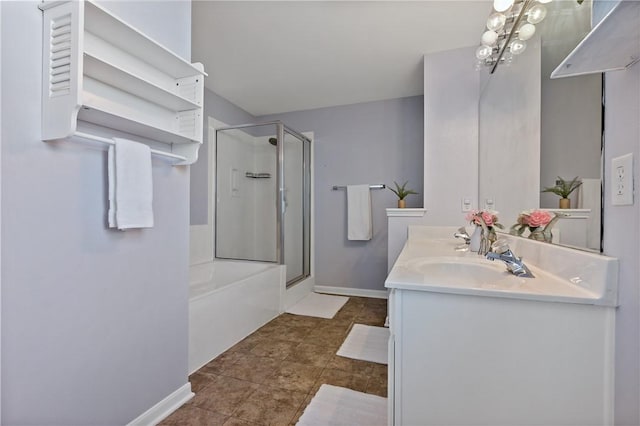 full bathroom featuring baseboards, double vanity, a sink, a shower with door, and a washtub