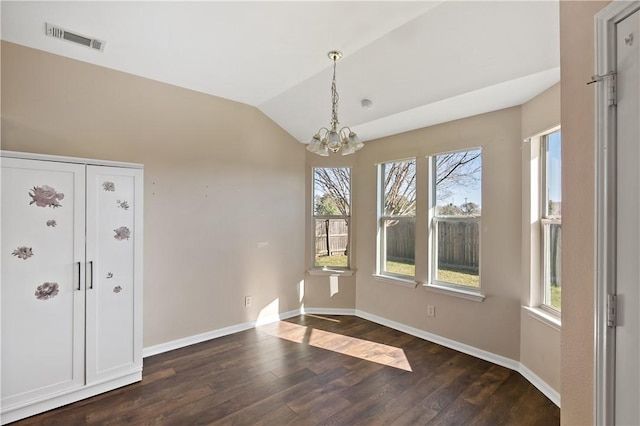 unfurnished dining area featuring visible vents, baseboards, dark wood finished floors, and vaulted ceiling