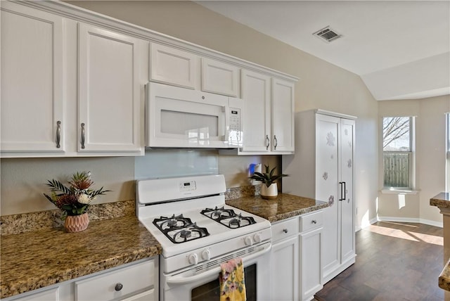 kitchen featuring white appliances, dark wood-style floors, visible vents, lofted ceiling, and white cabinetry