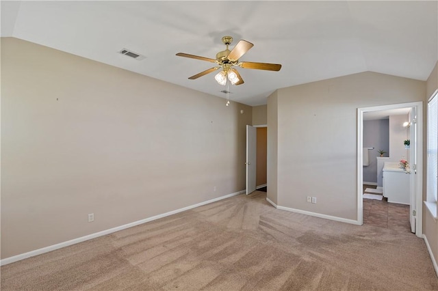 unfurnished bedroom featuring lofted ceiling, carpet flooring, baseboards, and visible vents