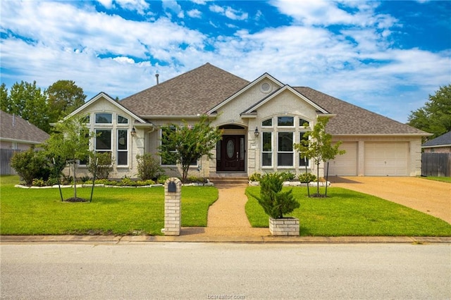 view of front facade with a garage and a front lawn