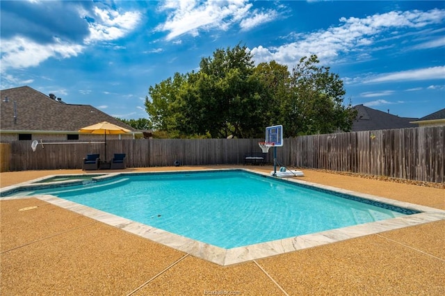 view of swimming pool with a patio area and an in ground hot tub