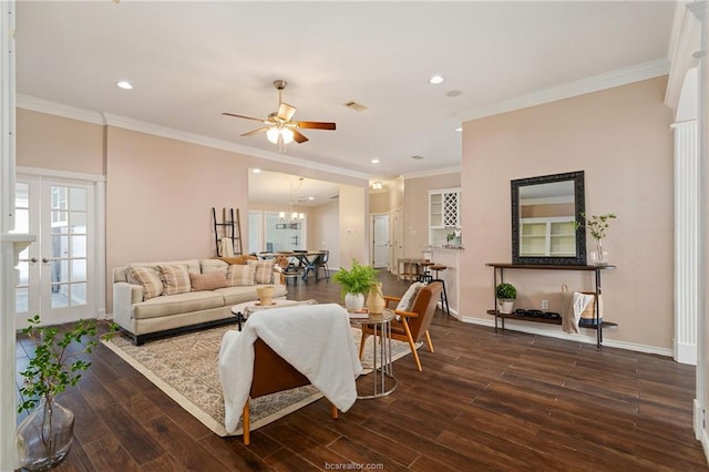 living room featuring french doors, dark hardwood / wood-style flooring, ceiling fan with notable chandelier, and ornamental molding