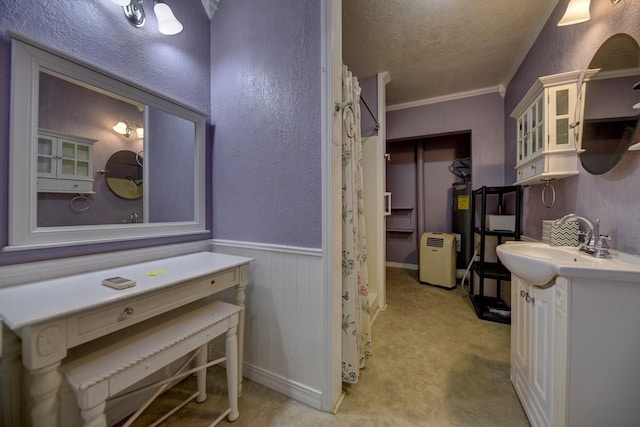 bathroom with a textured ceiling, ornamental molding, and vanity