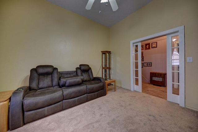 living room featuring ceiling fan, heating unit, light carpet, and french doors