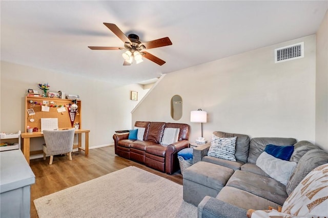 living room featuring a ceiling fan, wood finished floors, and visible vents