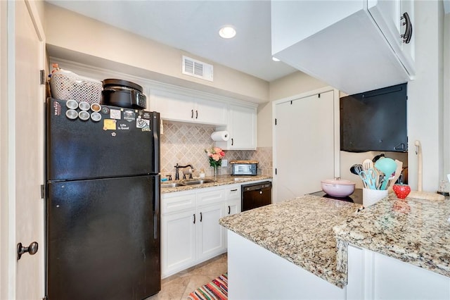 kitchen with visible vents, black appliances, a sink, white cabinets, and decorative backsplash