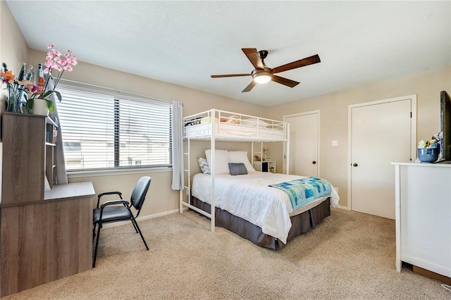 carpeted bedroom featuring baseboards and ceiling fan