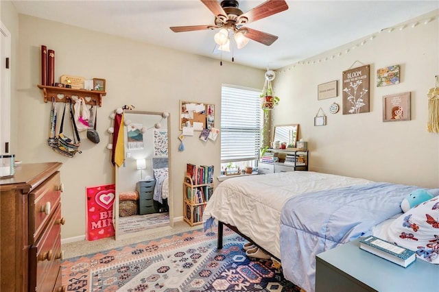 bedroom featuring carpet, baseboards, and ceiling fan