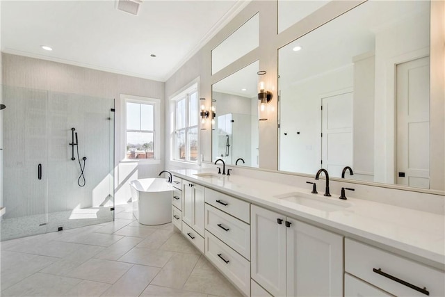full bathroom featuring a sink, a shower stall, a freestanding bath, and crown molding