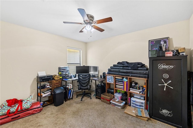 carpeted office space featuring ceiling fan