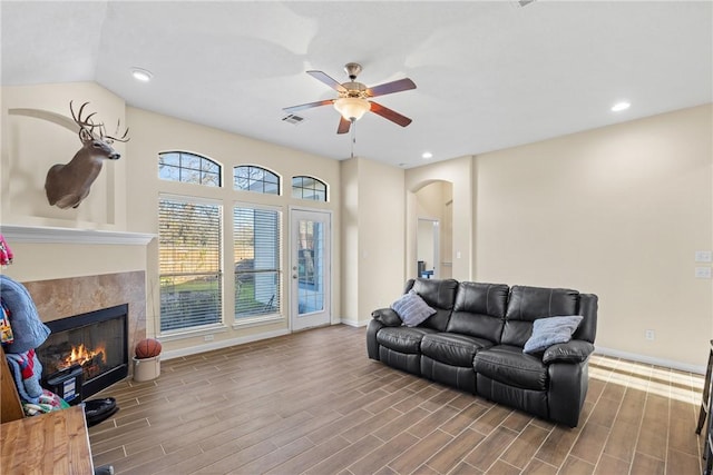 living room featuring a fireplace and ceiling fan