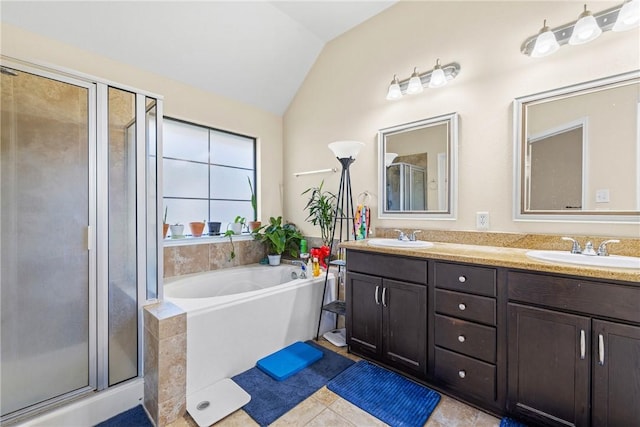 bathroom featuring tile patterned floors, vanity, independent shower and bath, and vaulted ceiling