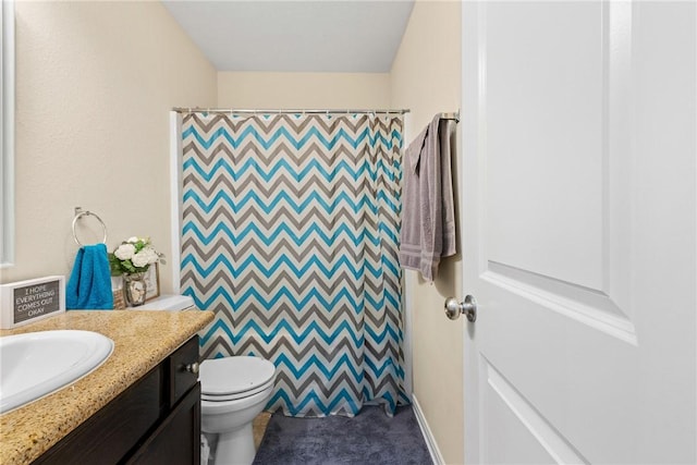 bathroom with vanity, a shower with shower curtain, and toilet