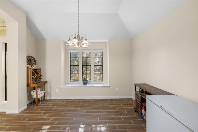 dining space featuring lofted ceiling and a chandelier