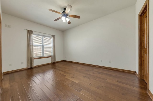 empty room with ceiling fan, baseboards, and wood finished floors