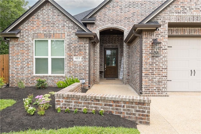 4813 Coopers Hawk Dr, College Station, TX 77845 - doorway to property with an attached garage and brick siding