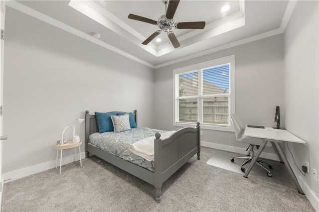 4813 Coopers Hawk Dr, College Station, TX 77845 - bedroom featuring ornamental molding, a tray ceiling, baseboards, light carpet, and a ceiling fan