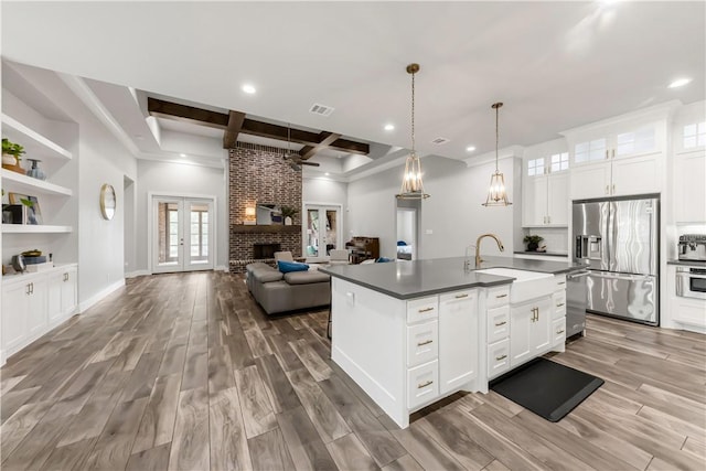 4813 Coopers Hawk Dr, College Station, TX 77845 - kitchen with stainless steel appliances, a sink, coffered ceiling, recessed lighting, and beam ceiling