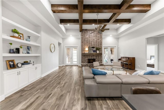 4813 Coopers Hawk Dr, College Station, TX 77845 - living area with ceiling fan, baseboards, light wood finished floors, beam ceiling, and a high ceiling