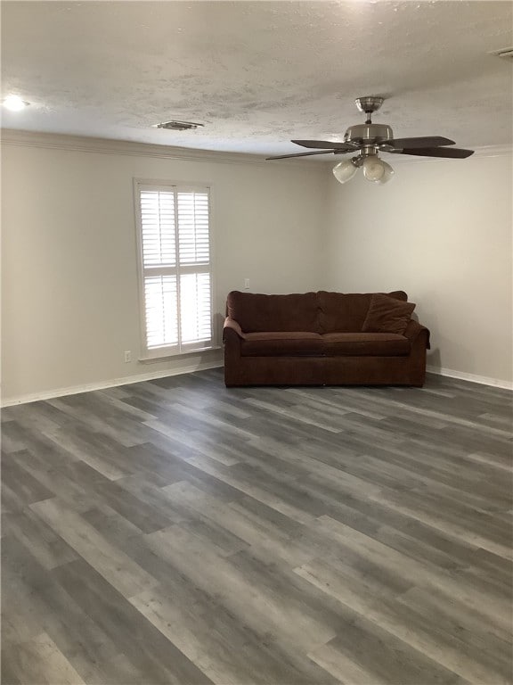 living room with a textured ceiling, crown molding, ceiling fan, and dark hardwood / wood-style floors