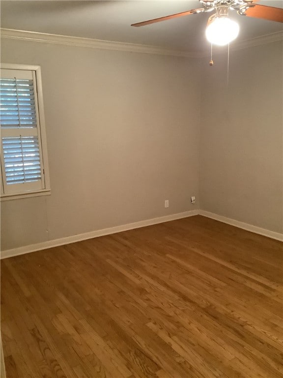 spare room with hardwood / wood-style floors and ornamental molding