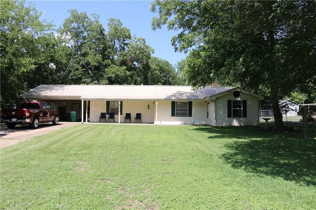 106 N Minden St, Madisonville, TX 77864 - view of front of property with driveway, a front lawn, an attached carport, and a metal roof