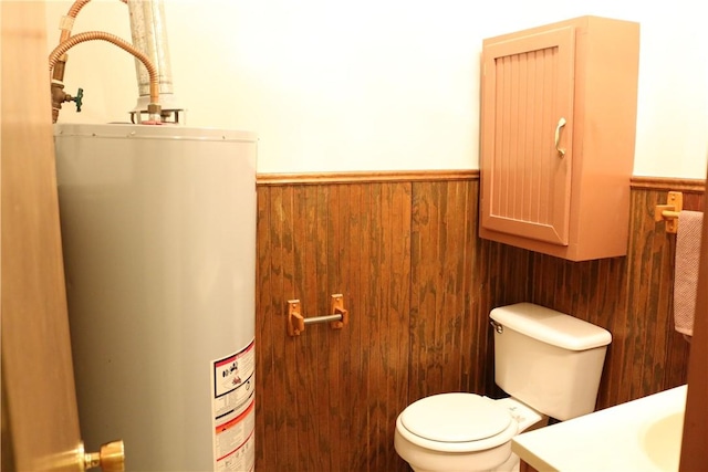 106 N Minden St, Madisonville, TX 77864 - bathroom featuring water heater, wainscoting, vanity, and wood walls