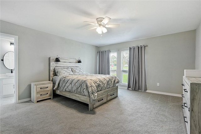 bedroom with ensuite bathroom, ceiling fan, and light carpet