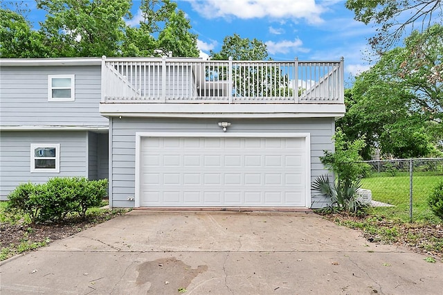 view of front of home featuring a garage and a balcony