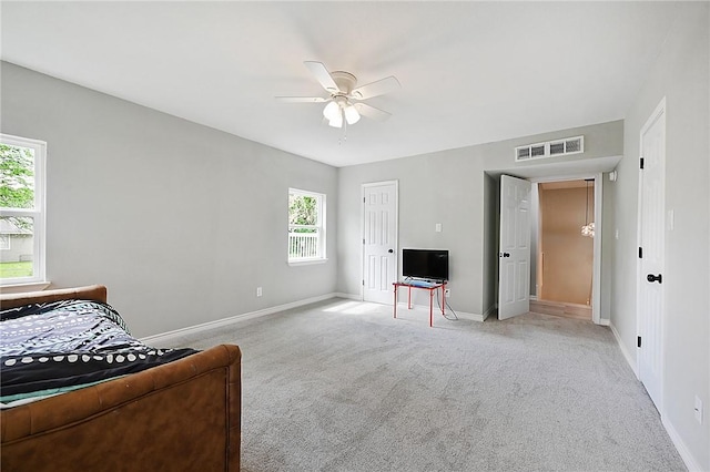 bedroom featuring light carpet and ceiling fan