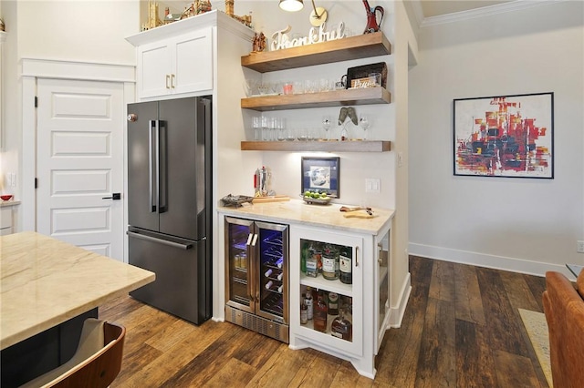 bar featuring wine cooler, white cabinets, dark hardwood / wood-style flooring, crown molding, and high end fridge