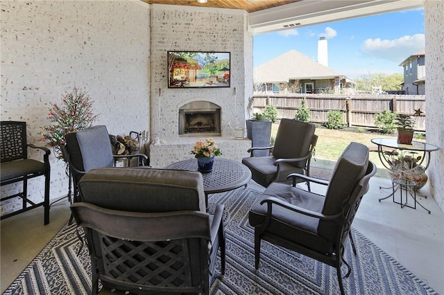 view of patio / terrace with an outdoor brick fireplace and ceiling fan