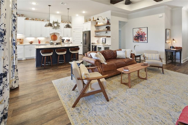 living room featuring ceiling fan and dark hardwood / wood-style flooring