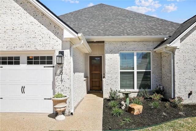 doorway to property with a garage