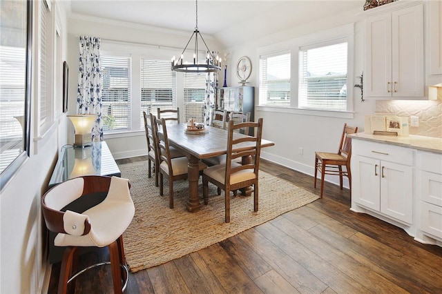 dining area featuring ornamental molding, a wealth of natural light, and dark hardwood / wood-style flooring