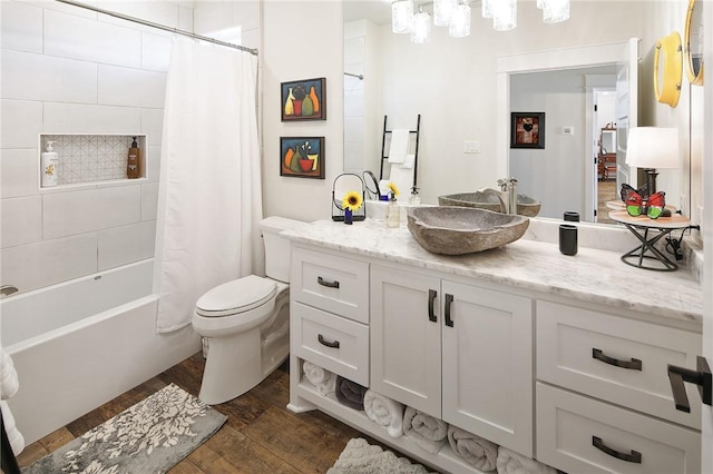 full bathroom with toilet, vanity, shower / bathtub combination with curtain, and hardwood / wood-style floors