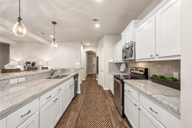 kitchen with decorative light fixtures, white cabinetry, sink, light stone counters, and stainless steel appliances