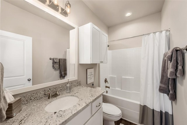 full bathroom with shower / bathtub combination with curtain, vanity, and toilet