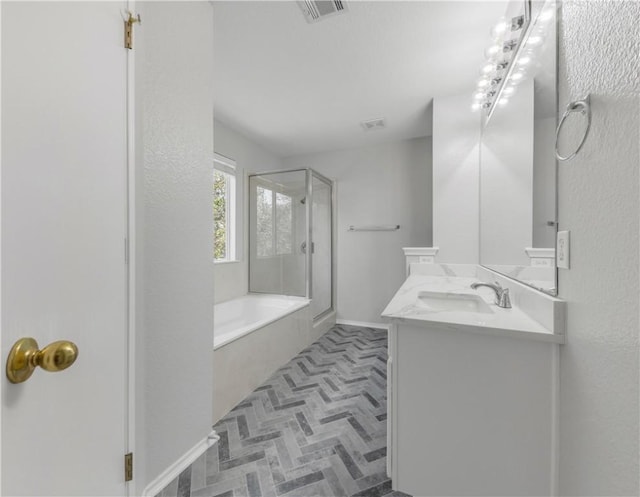 bathroom featuring vanity and independent shower and bath